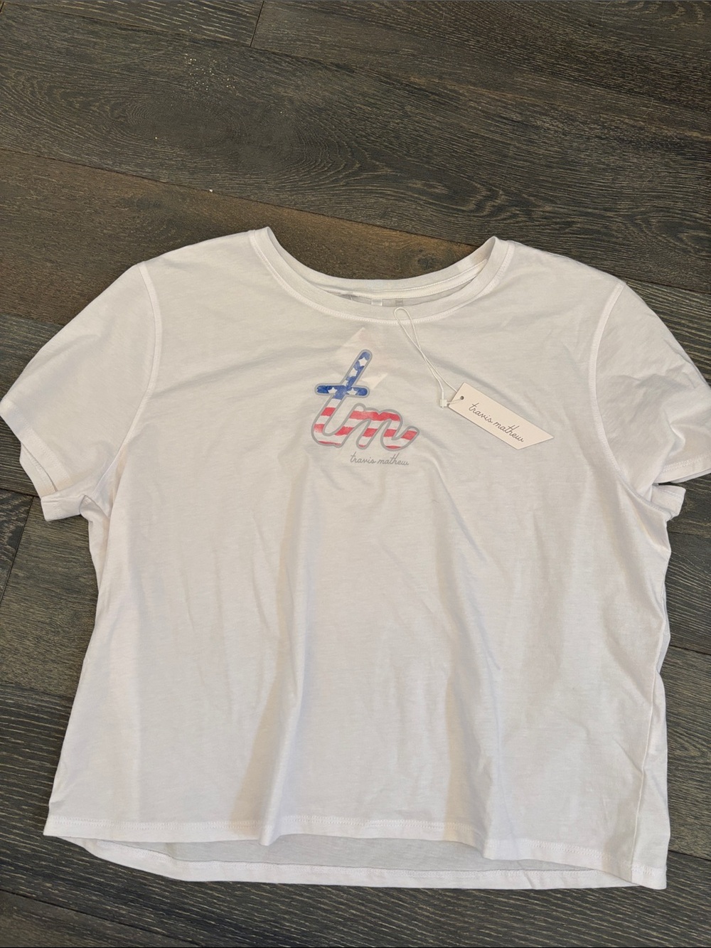 Travis Mathew White Short Sleeve Tee with Red & Blue Script Logo